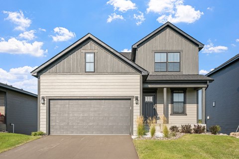 a house with a garage door in front of it